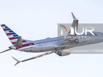 American Airlines Boeing 737 MAX 8 passenger aircraft spotted during takeoff and flying in front of the airport terminal, air traffic contro...