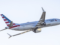 American Airlines Boeing 737 MAX 8 passenger aircraft spotted during takeoff and flying in front of the airport terminal, air traffic contro...