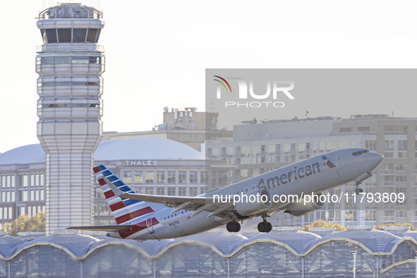 American Airlines Boeing 737 MAX 8 passenger aircraft spotted during takeoff and flying in front of the airport terminal, air traffic contro...