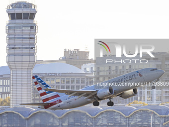 American Airlines Boeing 737 MAX 8 passenger aircraft spotted during takeoff and flying in front of the airport terminal, air traffic contro...