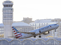 American Airlines Boeing 737 MAX 8 passenger aircraft spotted during takeoff and flying in front of the airport terminal, air traffic contro...