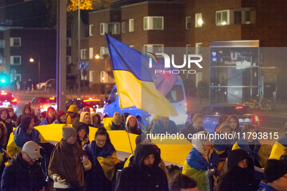 Two hundred people take part in a demonstration to mark 1,000 days since the full-scale war between Ukraine and Russia in Cologne, Germany,...