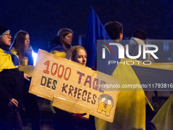 Two hundred people take part in a demonstration to mark 1,000 days since the full-scale war between Ukraine and Russia in Cologne, Germany,...