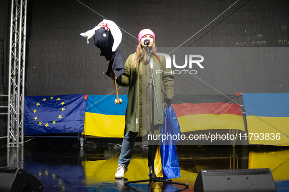 A protester holds a symbolic Taurus toy to demand the German government supply Ukraine with Taurus missiles on the stage as two hundred peop...