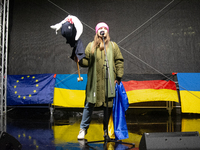 A protester holds a symbolic Taurus toy to demand the German government supply Ukraine with Taurus missiles on the stage as two hundred peop...