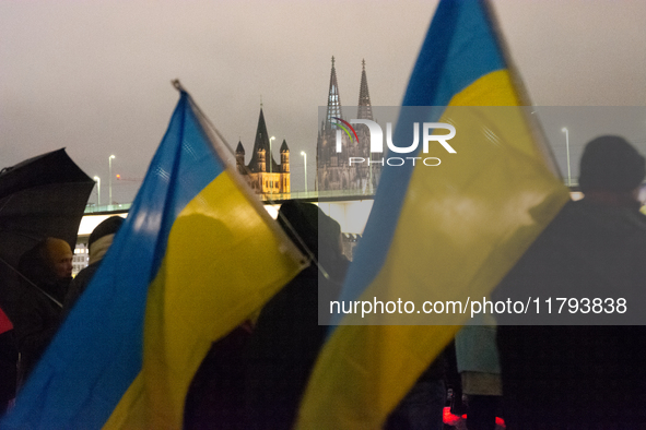 Two hundred people take part in a demonstration to mark 1,000 days since the full-scale war between Ukraine and Russia in Cologne, Germany,...