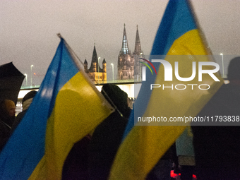 Two hundred people take part in a demonstration to mark 1,000 days since the full-scale war between Ukraine and Russia in Cologne, Germany,...