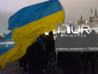 Two hundred people take part in a demonstration to mark 1,000 days since the full-scale war between Ukraine and Russia in Cologne, Germany,...