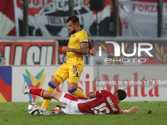 In Ta' Qali, Malta, on November 19, 2024, Moises San Nicolas of Andorra is closely challenged by Trent Buhagiar of Malta during the UEFA Nat...