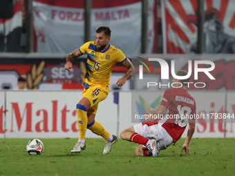 In Ta' Qali, Malta, on November 19, 2024, Moises San Nicolas of Andorra is closely challenged by Trent Buhagiar of Malta during the UEFA Nat...