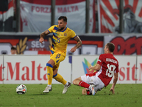 In Ta' Qali, Malta, on November 19, 2024, Moises San Nicolas of Andorra is closely challenged by Trent Buhagiar of Malta during the UEFA Nat...