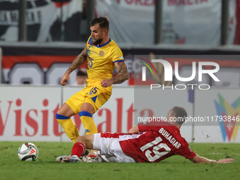 In Ta' Qali, Malta, on November 19, 2024, Moises San Nicolas of Andorra is closely challenged by Trent Buhagiar of Malta during the UEFA Nat...