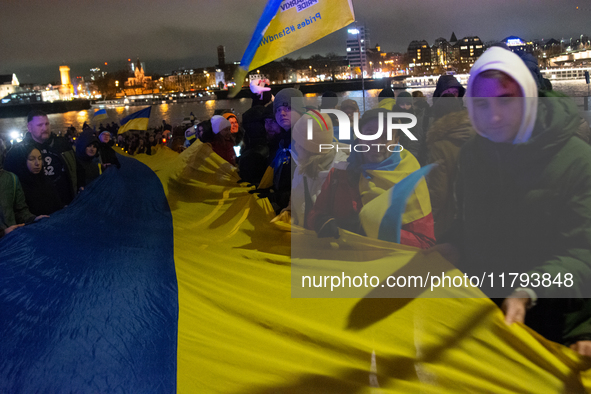 Two hundred people take part in a demonstration to mark 1,000 days since the full-scale war between Ukraine and Russia in Cologne, Germany,...