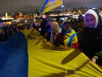 Two hundred people take part in a demonstration to mark 1,000 days since the full-scale war between Ukraine and Russia in Cologne, Germany,...