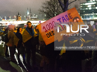 Two hundred people take part in a demonstration to mark 1,000 days since the full-scale war between Ukraine and Russia in Cologne, Germany,...