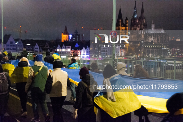 Two hundred people take part in a demonstration to mark 1,000 days since the full-scale war between Ukraine and Russia in Cologne, Germany,...