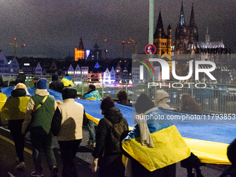 Two hundred people take part in a demonstration to mark 1,000 days since the full-scale war between Ukraine and Russia in Cologne, Germany,...