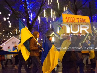 Two hundred people take part in a demonstration to mark 1,000 days since the full-scale war between Ukraine and Russia in Cologne, Germany,...