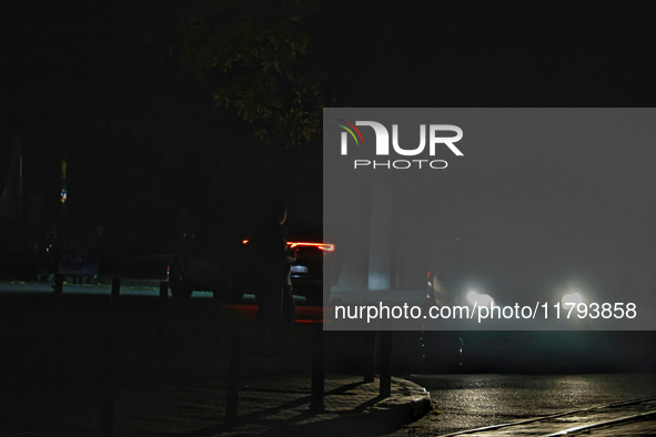 Silhouettes of people appear on the street during a power outage in Odesa, Ukraine, on November 18, 2024. 