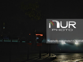 Silhouettes of people appear on the street during a power outage in Odesa, Ukraine, on November 18, 2024. (