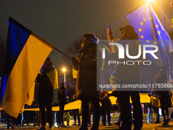 Two hundred people take part in a demonstration to mark 1,000 days since the full-scale war between Ukraine and Russia in Cologne, Germany,...