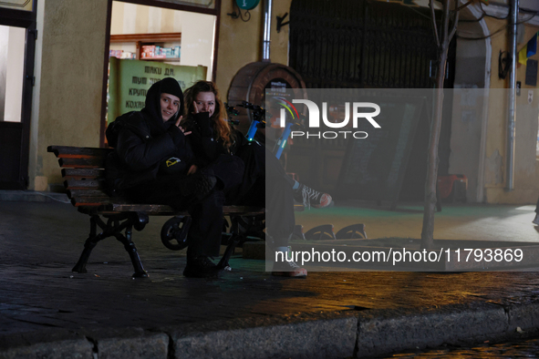 Local citizens sit on a bench during a power outage in Odesa, Ukraine, on November 18, 2024. NO USE RUSSIA. NO USE BELARUS. 