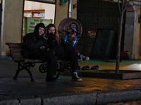 Local citizens sit on a bench during a power outage in Odesa, Ukraine, on November 18, 2024. NO USE RUSSIA. NO USE BELARUS. (