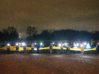 Protesters light up the Ukraine flags at the end of a march as two hundred people take part in a demonstration to mark 1000 days since the f...