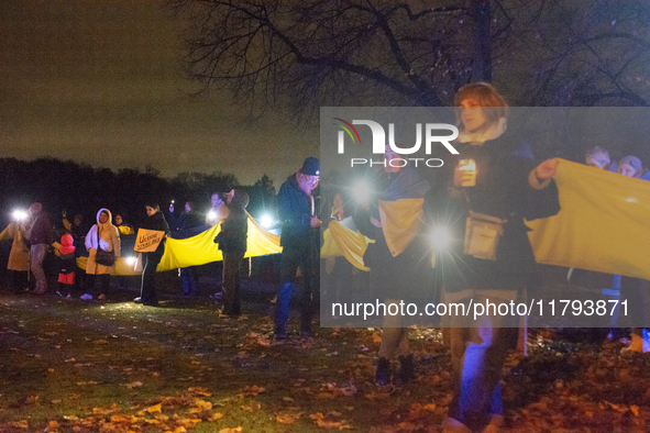 Protesters light up the Ukraine flags at the end of a march as two hundred people take part in a demonstration to mark 1000 days since the f...