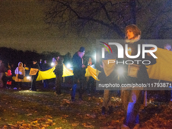 Protesters light up the Ukraine flags at the end of a march as two hundred people take part in a demonstration to mark 1000 days since the f...