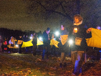 Protesters light up the Ukraine flags at the end of a march as two hundred people take part in a demonstration to mark 1000 days since the f...