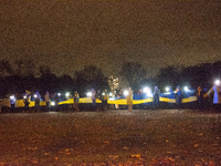 Protesters light up the Ukraine flags at the end of a march as two hundred people take part in a demonstration to mark 1000 days since the f...