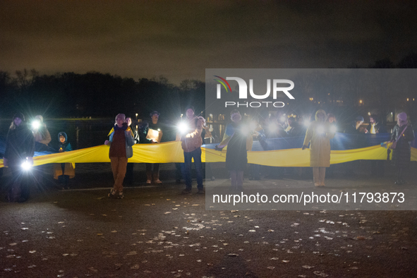 Protesters light up the Ukraine flags at the end of a march as two hundred people take part in a demonstration to mark 1000 days since the f...