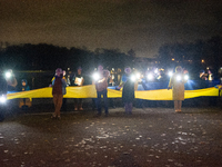 Protesters light up the Ukraine flags at the end of a march as two hundred people take part in a demonstration to mark 1000 days since the f...