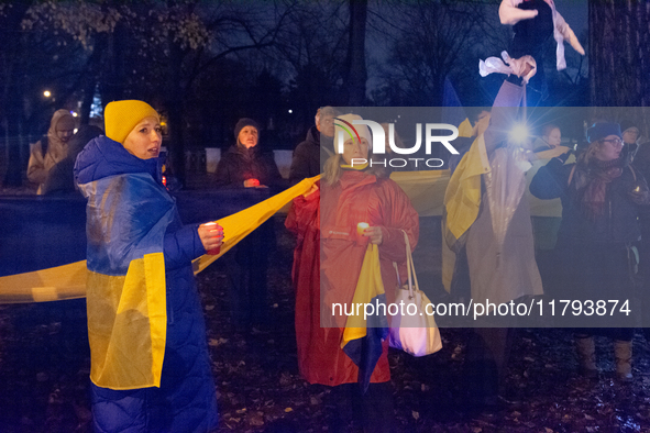 Protesters light up the Ukraine flags at the end of a march as two hundred people take part in a demonstration to mark 1000 days since the f...