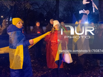 Protesters light up the Ukraine flags at the end of a march as two hundred people take part in a demonstration to mark 1000 days since the f...