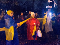 Protesters light up the Ukraine flags at the end of a march as two hundred people take part in a demonstration to mark 1000 days since the f...