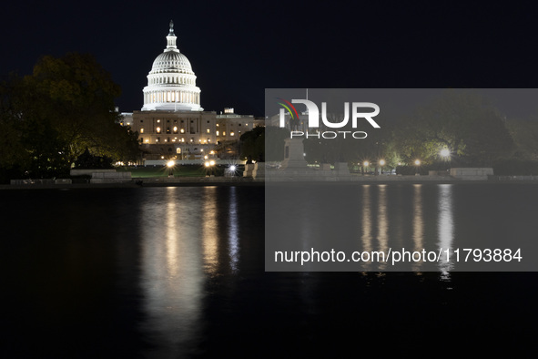 Night view with dark sky of the illuminated US Capitol reflecting on the pool water surface. The Capitol is the seat of the United States Co...