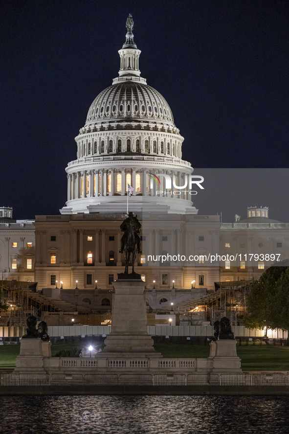 Night view with dark sky of the illuminated US Capitol reflecting on the pool water surface. The Capitol is the seat of the United States Co...