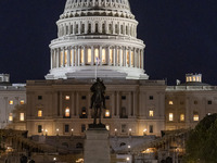 Night view with dark sky of the illuminated US Capitol reflecting on the pool water surface. The Capitol is the seat of the United States Co...