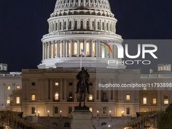 Night view with dark sky of the illuminated US Capitol reflecting on the pool water surface. The Capitol is the seat of the United States Co...