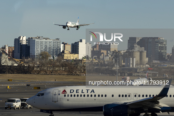 Frontier Airlines Airbus A320neo passenger aircraft spotted on final approach flying for landing in LaGuardia Airport over Delta Air Lines B...