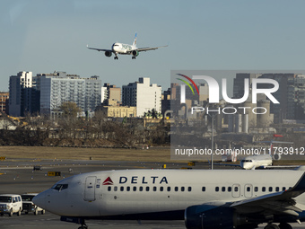 Frontier Airlines Airbus A320neo passenger aircraft spotted on final approach flying for landing in LaGuardia Airport over Delta Air Lines B...