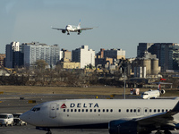 Frontier Airlines Airbus A320neo passenger aircraft spotted on final approach flying for landing in LaGuardia Airport over Delta Air Lines B...