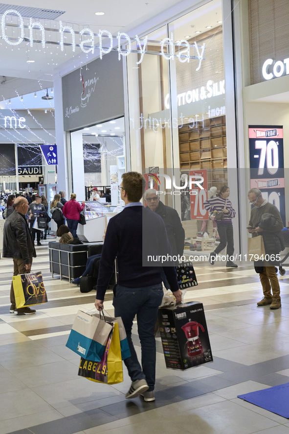 Promotional signage advertises up to 70% off for Black Friday at a clothing store in Foggia, Italy, on November 29, 2019. The image highligh...