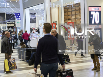 Promotional signage advertises up to 70% off for Black Friday at a clothing store in Foggia, Italy, on November 29, 2019. The image highligh...