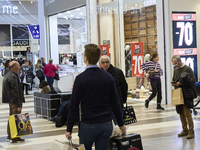 Promotional signage advertises up to 70% off for Black Friday at a clothing store in Foggia, Italy, on November 29, 2019. The image highligh...