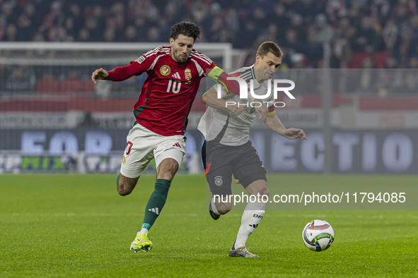 Dominik Szoboszlai of Hungary competes for the ball with Joshua Kimmich of Germany during the UEFA Nations League Group match at Puskas Aren...