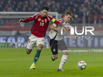 Dominik Szoboszlai of Hungary competes for the ball with Joshua Kimmich of Germany during the UEFA Nations League Group match at Puskas Aren...