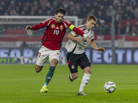 Dominik Szoboszlai of Hungary competes for the ball with Joshua Kimmich of Germany during the UEFA Nations League Group match at Puskas Aren...